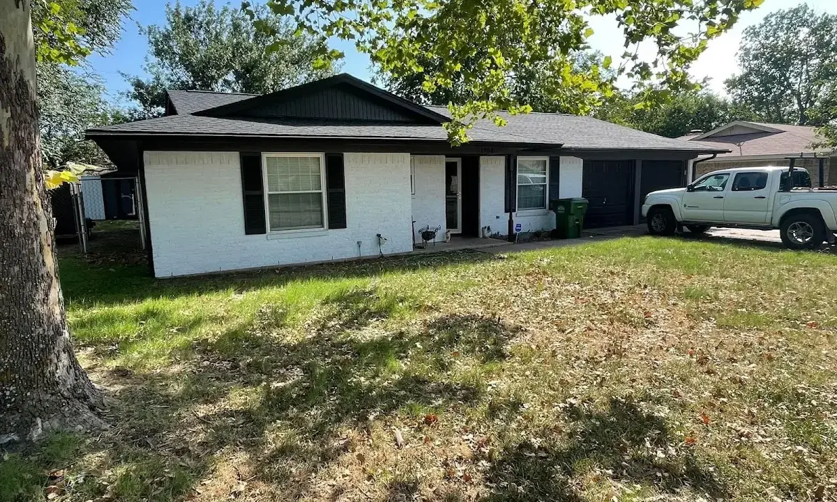 Professional roofing crew working on a residential roof in Sedalia
